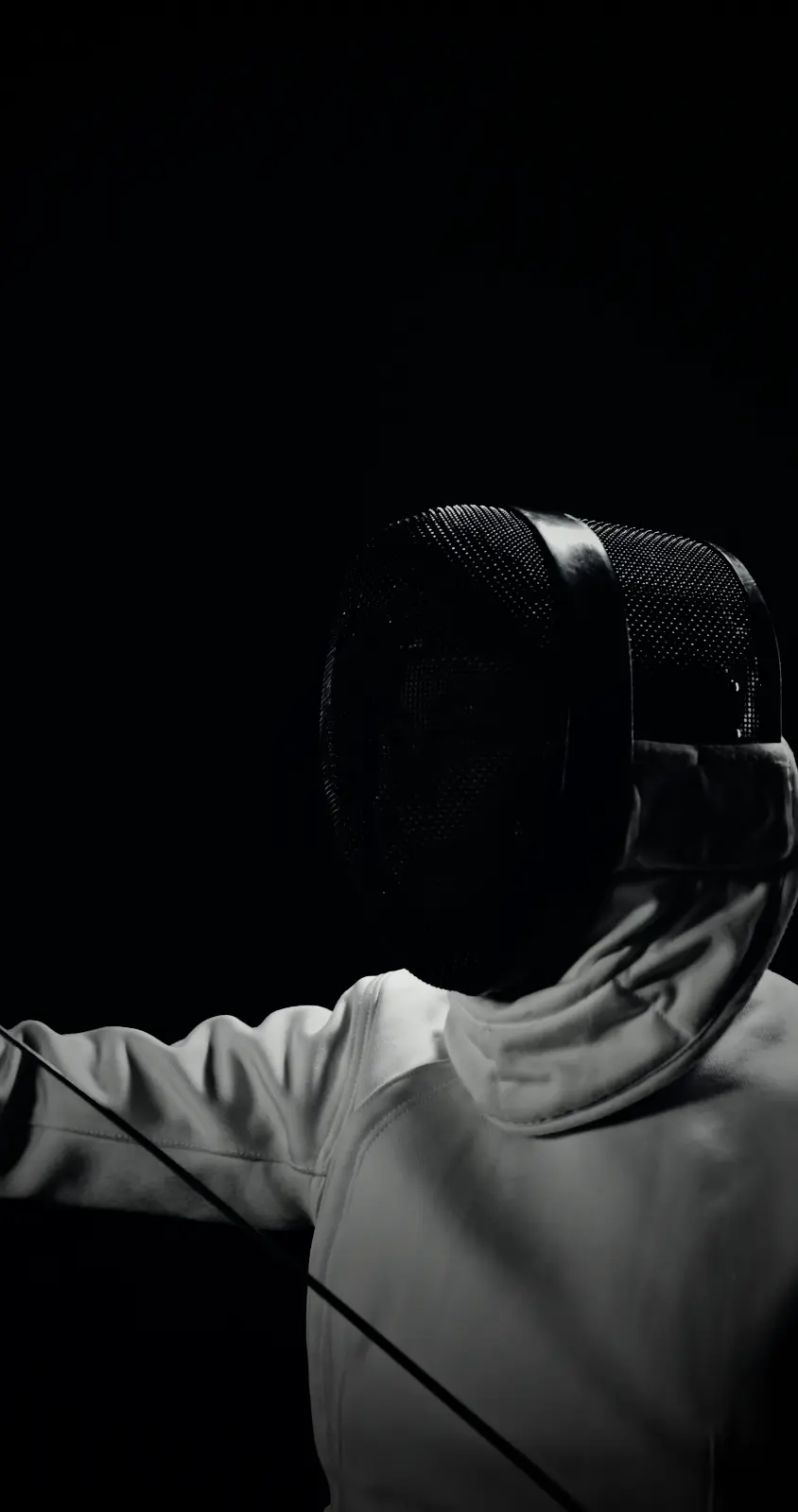A masked fencer with her blade raised